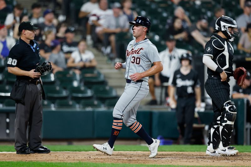 Aug 26, 2024; Chicago, Illinois, USA;  Detroit Tigers outfielder Kerry Carpenter (30) scores against the Chicago White Sox during the fifth inning at Guaranteed Rate Field. Mandatory Credit: Kamil Krzaczynski-USA TODAY Sports