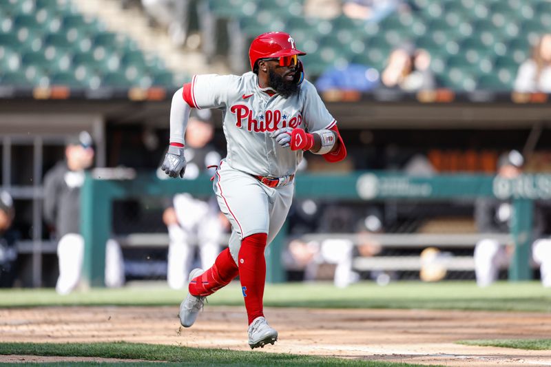 Apr 18, 2023; Chicago, Illinois, USA; Philadelphia Phillies second baseman Josh Harrison (2) runs to first base after hitting a two-run single against the Chicago White Sox during the third inning of game one of the doubleheader at Guaranteed Rate Field. Mandatory Credit: Kamil Krzaczynski-USA TODAY Sports