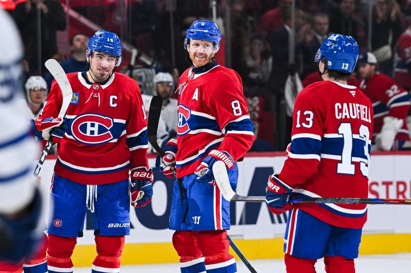 Sep 25, 2025; Montreal, Quebec, CAN; Montreal Canadiens defenseman Mike Matheson (8) celebrates with center Nick Suzuki (14) and right wing Cole Caufield (13) his goal against the Toronto Maple Leafs during the first period at Bell Centre. Mandatory Credit: David Kirouac-Imagn Images