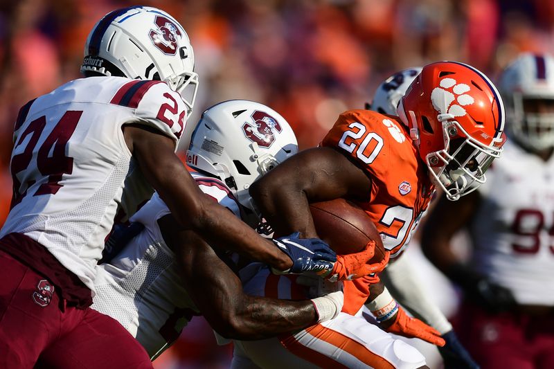 Sep 11, 2021; Clemson, South Carolina, USA; Clemson Tigers running back Kobe Pace (20) carries the ball South Carolina State Bulldogs defensive end Chris Simmons (24) during the first quarter at Memorial Stadium. Mandatory Credit: Adam Hagy-USA TODAY Sports