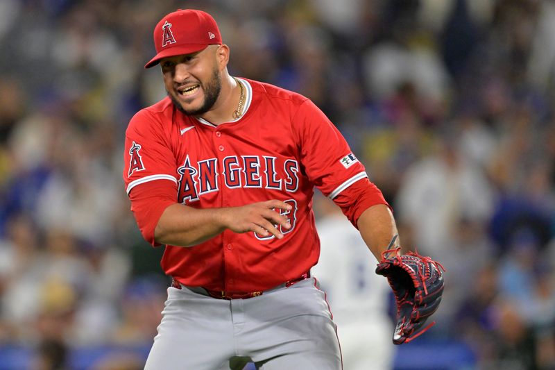 Jun 21, 2024; Los Angeles, California, USA;  Los Angeles Angels relief pitcher Carlos Estevez (53) reacts after striking out Los Angeles Dodgers second baseman Gavin Lux (9) in the 10th inning earning a save in the game at Dodger Stadium. Mandatory Credit: Jayne Kamin-Oncea-USA TODAY Sports