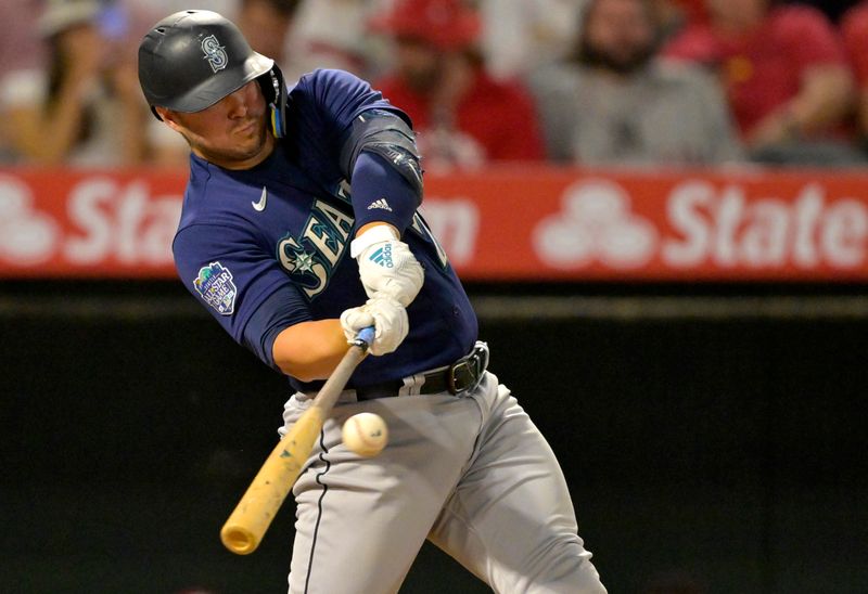 Aug 5, 2023; Anaheim, California, USA; Seattle Mariners first baseman Ty France (23) hits a RBI single in the eighth inning against the Los Angeles Angels at Angel Stadium. Mandatory Credit: Jayne Kamin-Oncea-USA TODAY Sports