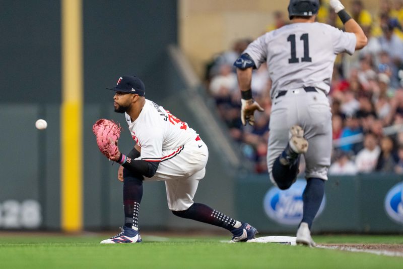 May 15, 2024; Minneapolis, Minnesota, USA; Minnesota Twins first base Carlos Santana (30) catches the ball retiring New York Yankees shortstop Anthony Volpe (11) in the seventh inning at Target Field. Mandatory Credit: Matt Blewett-USA TODAY Sports