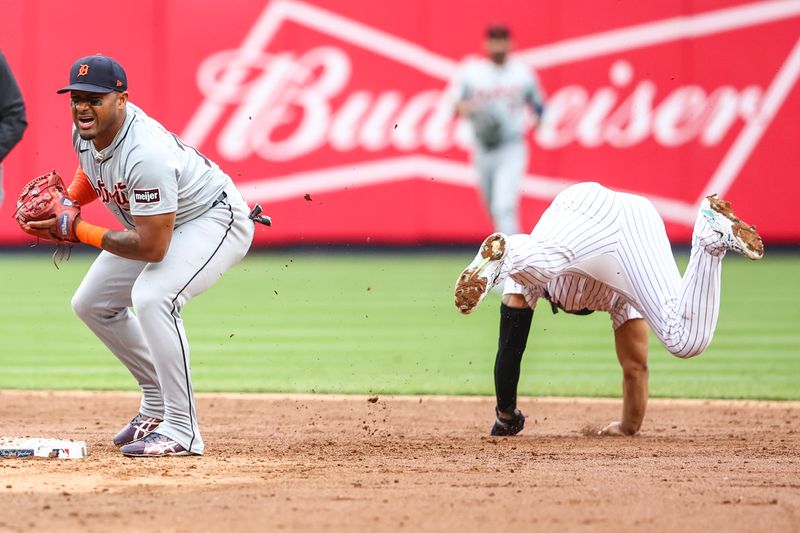 May 4, 2024; Bronx, New York, USA;  Detroit Tigers second base Andy Ibáñez (77) collides with New York Yankees second baseman Gleyber Torres (25) attempting to turn a double play in the sixth inning at Yankee Stadium. Mandatory Credit: Wendell Cruz-USA TODAY Sports