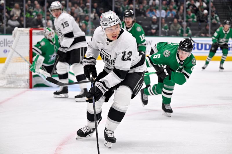 Dec 15, 2025; Dallas, Texas, USA; Los Angeles Kings left wing Trevor Moore (12) controls the puck in the Dallas Stars zone during the first period at the American Airlines Center. Mandatory Credit: Jerome Miron-Imagn Images