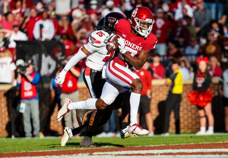 Oct 30, 2021; Norman, Oklahoma, USA;  Oklahoma Sooners wide receiver Marvin Mims (17) catches a touchdown pass in front of Texas Tech Red Raiders defensive back Dadrion Taylor-Demerson (25) during the second half at Gaylord Family-Oklahoma Memorial Stadium. Mandatory Credit: Kevin Jairaj-USA TODAY Sports
