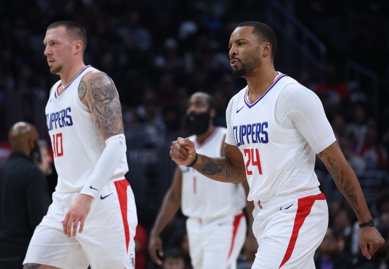 LOS ANGELES, CALIFORNIA - JANUARY 21: Norman Powell #24 of the LA Clippers celebrates as he walks to the bench with Daniel Theis #10 after a timeout during a 125-114 Clippers win over the Brooklyn Nets at Crypto.com Arena on January 21, 2024 in Los Angeles, California. User is consenting to the terms and conditions of the Getty Images License Agreement. (Photo by Harry How/Getty Images)