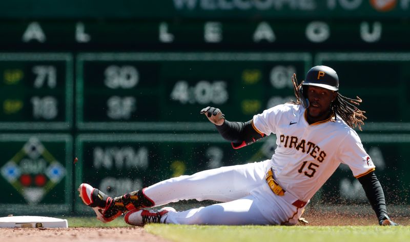 Apr 7, 2024; Pittsburgh, Pennsylvania, USA;  Pittsburgh Pirates shortstop Oneil Cruz (15) slides into second base with a double against the Baltimore Orioles during the third inning at PNC Park. Mandatory Credit: Charles LeClaire-USA TODAY Sports