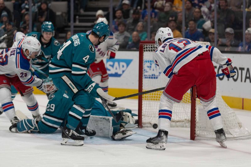 Jan 23, 2024; San Jose, California, USA; New York Rangers left wing Alexis Lafreniere (13) and San Jose Sharks defenseman Kyle Burroughs (4) watches the puck enter the goal past San Jose Sharks goaltender Mackenzie Blackwood (29) during the first period at SAP Center at San Jose. Mandatory Credit: Stan Szeto-USA TODAY Sports