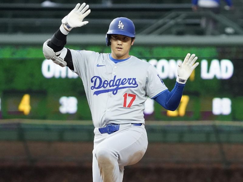 Apr 7, 2024; Chicago, Illinois, USA; Los Angeles Dodgers designated hitter Shohei Ohtani (17) gestures after hitting a one run double against the Chicago Cubs during the eighth inning at Wrigley Field. Mandatory Credit: David Banks-USA TODAY Sports