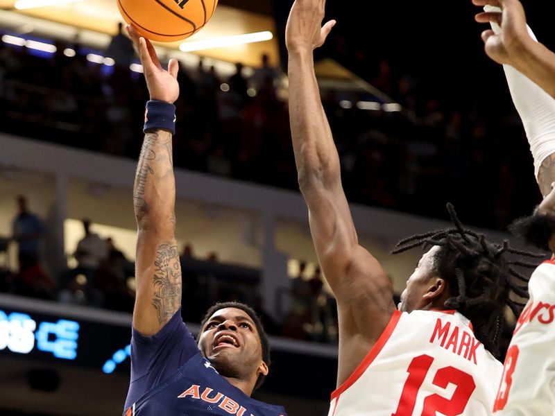 Mar 18, 2023; Birmingham, AL, USA; Auburn Tigers guard K.D. Johnson (0) shoots against Houston Cougars guard Tramon Mark (12) during the second half at Legacy Arena. Mandatory Credit: Vasha Hunt-USA TODAY Sports