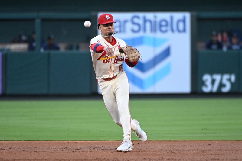 Sep 7, 2024; St. Louis, Missouri, USA; St. Louis Cardinals shortstop Masyn Winn (0) throws to first for an out against the Seattle Mariners in the second inning at Busch Stadium. Mandatory Credit: Joe Puetz-Imagn Images