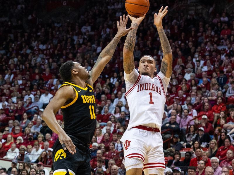 Feb 28, 2023; Bloomington, Indiana, USA; Indiana Hoosiers guard Jalen Hood-Schifino (1) shoots the ball while Iowa Hawkeyes guard Tony Perkins (11) defends in the first half at Simon Skjodt Assembly Hall. Mandatory Credit: Trevor Ruszkowski-USA TODAY Sports