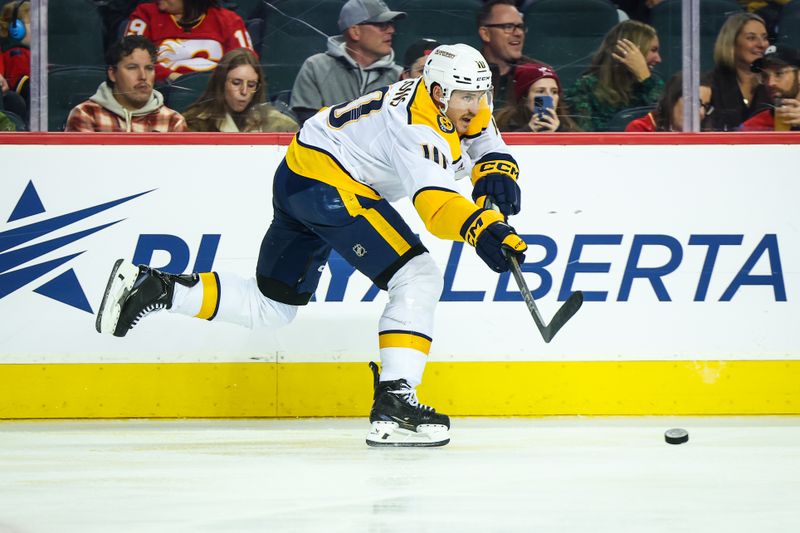 Nov 15, 2024; Calgary, Alberta, CAN; Nashville Predators center Colton Sissons (10) passes the puck against the Calgary Flames during the second period at Scotiabank Saddledome. Mandatory Credit: Sergei Belski-Imagn Images