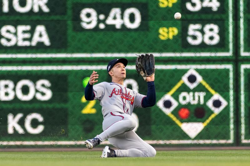 May 9, 2025; Pittsburgh, Pennsylvania, USA; Atlanta Braves right fielder Stuart Fairchild (17) makes a sliding catch for the third out of the fifth inning against the Pittsburgh Pirates at PNC Park. Mandatory Credit: Scott Galvin-Imagn Images