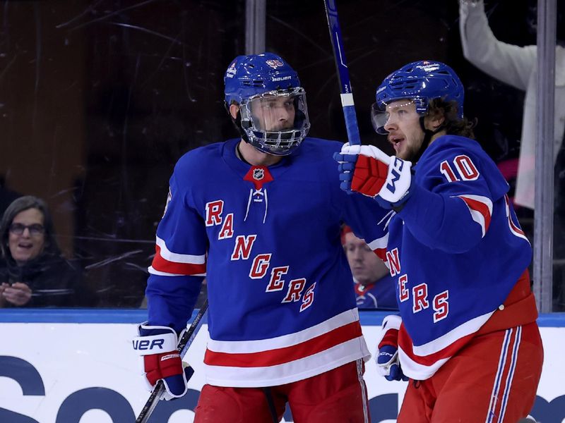 Oct 26, 2024; New York, New York, USA; New York Rangers defenseman Ryan Lindgren (55) celebrates his goal against the Anaheim Ducks with left wing Artemi Panarin (10) during the third period at Madison Square Garden. Mandatory Credit: Brad Penner-Imagn Images