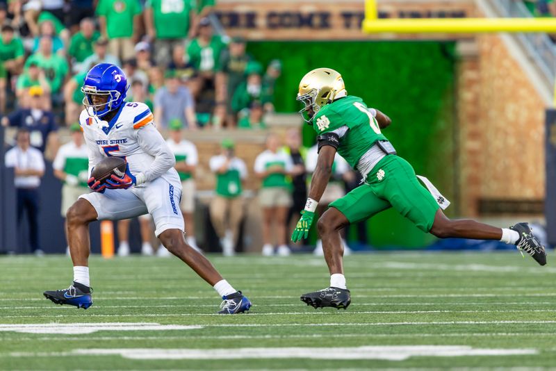 Oct 4, 2025; South Bend, Indiana, USA; Boise State Broncos wide receiver Chris Marshall (5) makes a catch as Notre Dame Fighting Irish cornerback Christian Gray (6) defends during the second half at Notre Dame Stadium. Mandatory Credit: Michael Caterina-Imagn Images