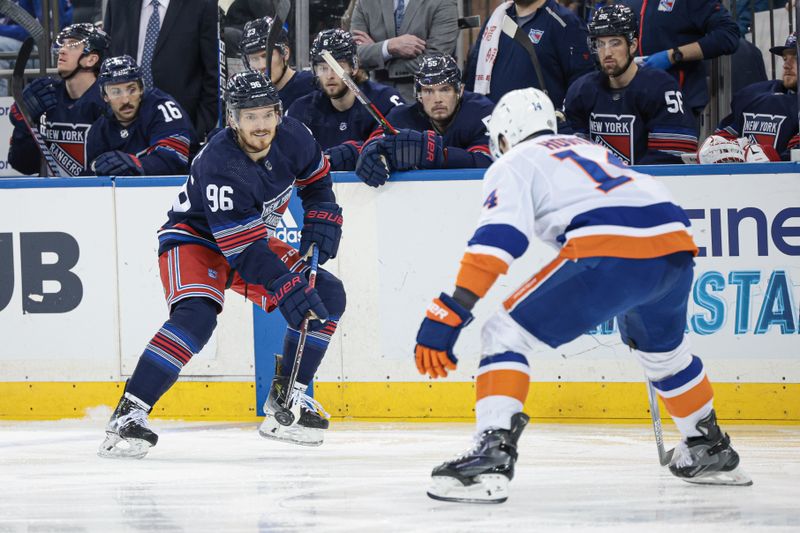 Mar 17, 2024; New York, New York, USA; New York Rangers center Jack Roslovic (96) passes the puck against New York Islanders center Bo Horvat (14) during the first period at Madison Square Garden. Mandatory Credit: Vincent Carchietta-USA TODAY Sports