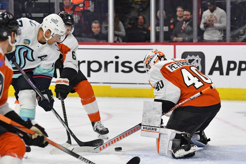 Feb 10, 2024; Philadelphia, Pennsylvania, USA; Philadelphia Flyers goaltender Cal Petersen (40) makes a save as defenseman Travis Sanheim (6) battles with Seattle Kraken center Jaden Schwartz (17) during the second period at Wells Fargo Center. Mandatory Credit: Eric Hartline-USA TODAY Sports