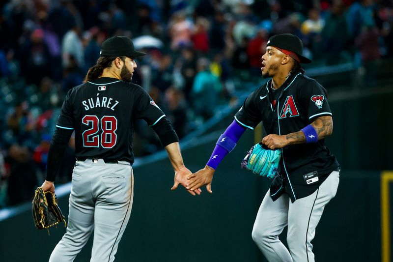 Apr 28, 2024; Seattle, Washington, USA; Arizona Diamondbacks third baseman Eugenio Suarez (28) and Arizona Diamondbacks second baseman Ketel Marte (4) celebrate following a 3-2 victory against the Seattle Mariners at T-Mobile Park. Mandatory Credit: Joe Nicholson-USA TODAY Sports