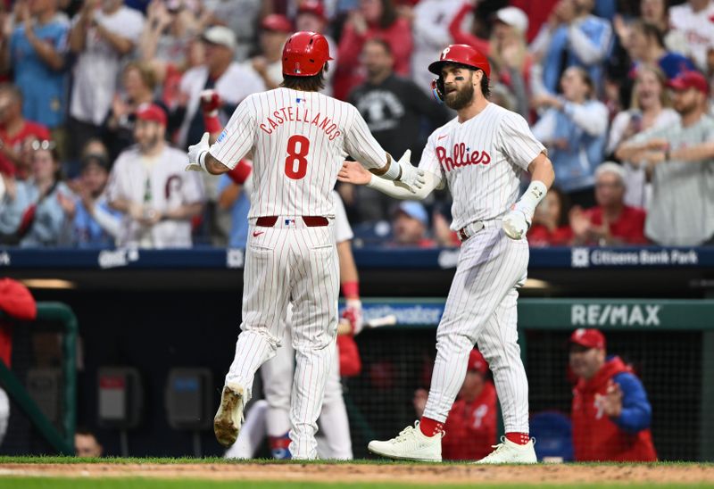 Sep 25, 2024; Philadelphia, Pennsylvania, USA; Philadelphia Phillies outfielder Nick Castellanos (8) reacts with first baseman Bryce Harper (3) after scoring against the Chicago Cubs in the first inning at Citizens Bank Park. Mandatory Credit: Kyle Ross-Imagn Images