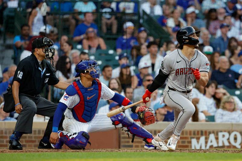 Jul 20, 2024; Chicago, Illinois, USA; Arizona Diamondbacks outfielder Alek Thomas (5) hits a solo home run against the Chicago Cubs during the fifth inning at Wrigley Field. Mandatory Credit: Kamil Krzaczynski-USA TODAY Sports