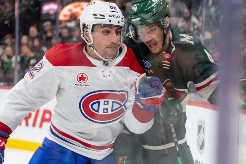 Nov 14, 2024; Saint Paul, Minnesota, USA; Montreal Canadiens left wing Lucas Condotta (82) checks Minnesota Wild defenseman Jon Merrill (4) in the third period at Xcel Energy Center. Mandatory Credit: Matt Blewett-Imagn Images