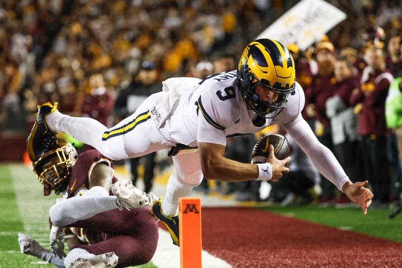 Oct 7, 2023; Minneapolis, Minnesota, USA; Michigan Wolverines quarterback J.J. McCarthy (9) dives for a  touchdown against the Minnesota Golden Gophers during the second quarter at Huntington Bank Stadium. Mandatory Credit: Matt Krohn-USA TODAY Sports