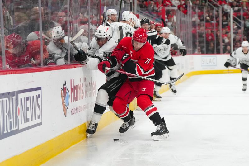 Feb 1, 2026; Raleigh, North Carolina, USA; aCarolina Hurricanes left wing Taylor Hall (71) checks Los Angeles Kings right wing Quinton Byfield (55) during the second period t Lenovo Center. Mandatory Credit: James Guillory-Imagn Images