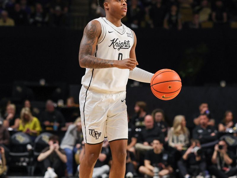 Feb 1, 2025; Orlando, Florida, USA; UCF Knights guard Jordan Ivy-Curry (0) brings the ball up court during the first half against the Brigham Young Cougars at Addition Financial Arena. Mandatory Credit: Mike Watters-Imagn Images