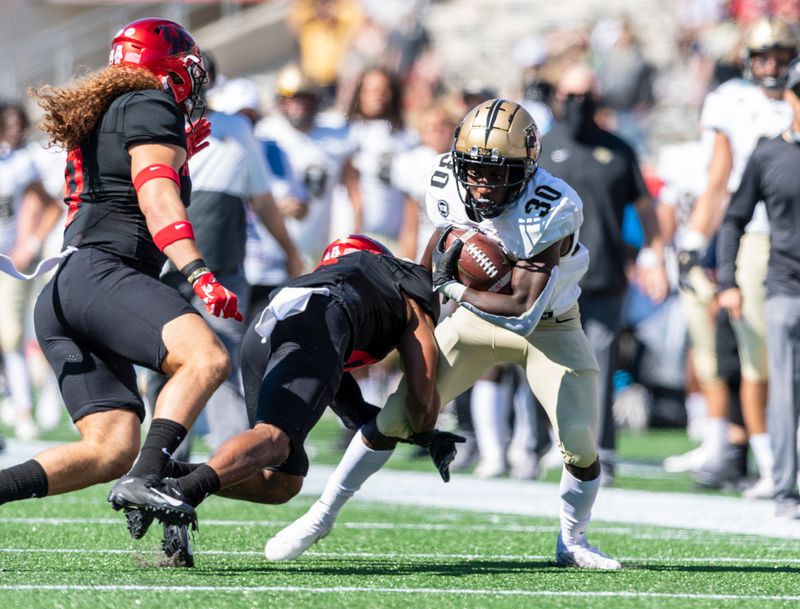 Oct 31, 2020; Houston, Texas, USA; Houston Cougars cornerback Damarion Williams (6) tackles UCF Knights running back Greg McCrae (30) during the first quarter at TDECU Stadium. Mandatory Credit: Maria Lysaker-USA TODAY Sports