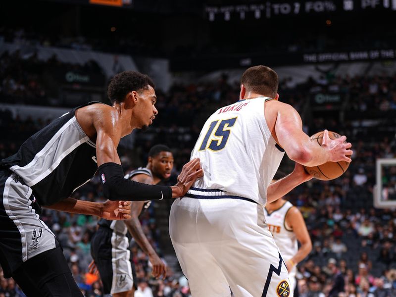 SAN ANTONIO, TX - APRIL 12: Victor Wembanyama #1 of the San Antonio Spurs plays defense against Nikola Jokic #15 of the Denver Nuggets during the game on April 12, 2024 at the Frost Bank Center in San Antonio, Texas. NOTE TO USER: User expressly acknowledges and agrees that, by downloading and or using this photograph, user is consenting to the terms and conditions of the Getty Images License Agreement. Mandatory Copyright Notice: Copyright 2024 NBAE (Photos by Garrett Ellwood/NBAE via Getty Images)