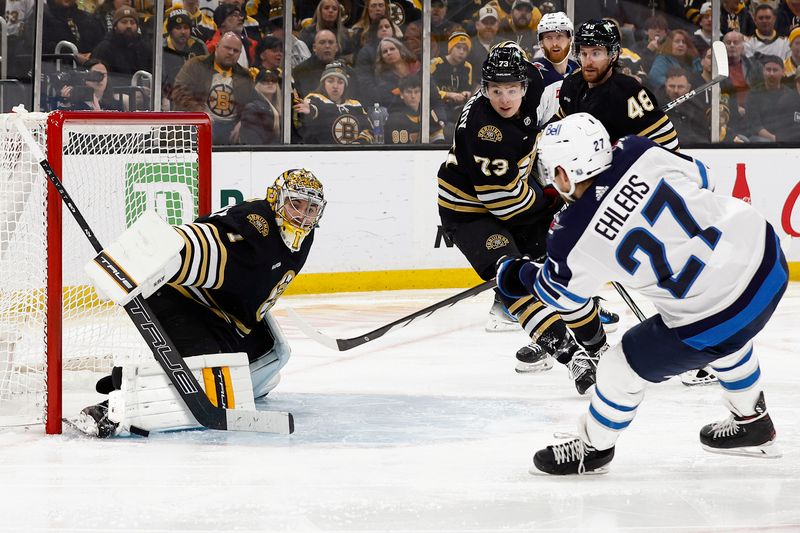 Jan 22, 2024; Boston, Massachusetts, USA; Boston Bruins goaltender Jeremy Swayman (1) makes a point blank save on Winnipeg Jets left wing Nikolaj Ehlers (27) during the third period at TD Garden. Mandatory Credit: Winslow Townson-USA TODAY Sports