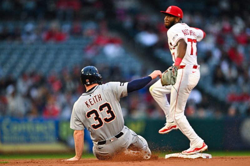 May 3, 2025; Anaheim, California, USA; Los Angeles Angels second baseman Tim Anderson (77) throws to first base for a double play against Detroit Tigers designated hitter Colt Keith (33) during the first second at Angel Stadium. Mandatory Credit: Jonathan Hui-Imagn Images