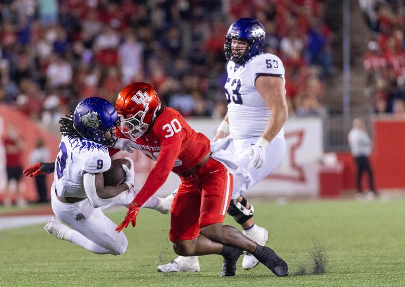 Sep 16, 2023; Houston, Texas, USA; TCU Horned Frogs running back Emani Bailey (9) is tackled by Houston Cougars linebacker Trimarcus Cheeks (30) in the second half at TDECU Stadium. Mandatory Credit: Thomas Shea-USA TODAY Sports