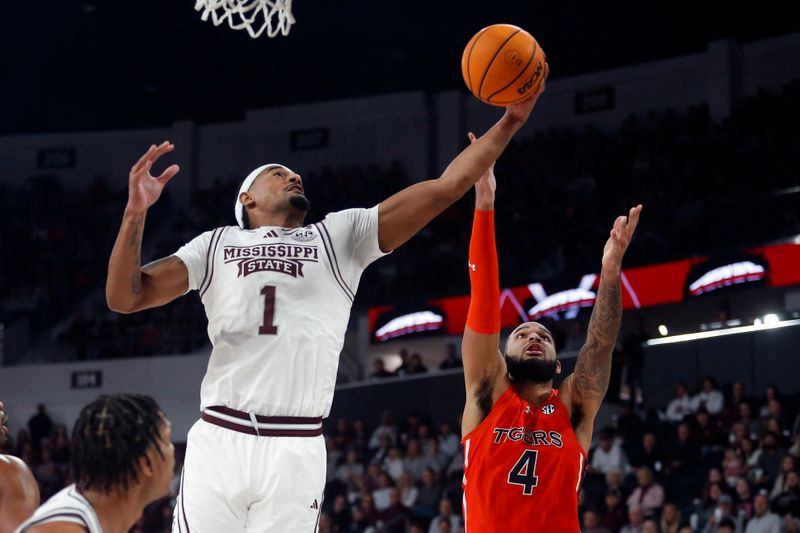 Jan 27, 2024; Starkville, Mississippi, USA; Mississippi State Bulldogs forward Tolu Smith (1) collects a rebound over Auburn Tigers forward/center Johni Broome (4) during the first half at Humphrey Coliseum. Mandatory Credit: Petre Thomas-USA TODAY Sports