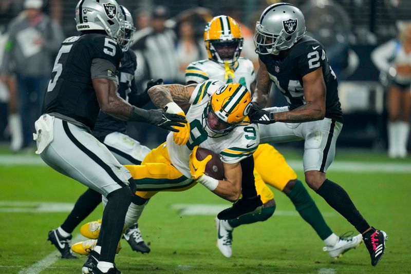 Las Vegas Raiders' Marcus Peters is called for a penalty as he tackles Green Bay Packers' Christian Watson during the second half of an NFL football game Monday, Oct. 9, 2023, in Las Vegas. (AP Photo/John Locher)