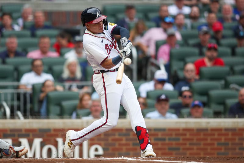 Sep 30, 2024; Atlanta, Georgia, USA; Atlanta Braves third baseman Gio Urshela (9) hits an RBI single against the New York Mets in the second inning at Truist Park. Mandatory Credit: Brett Davis-Imagn Images