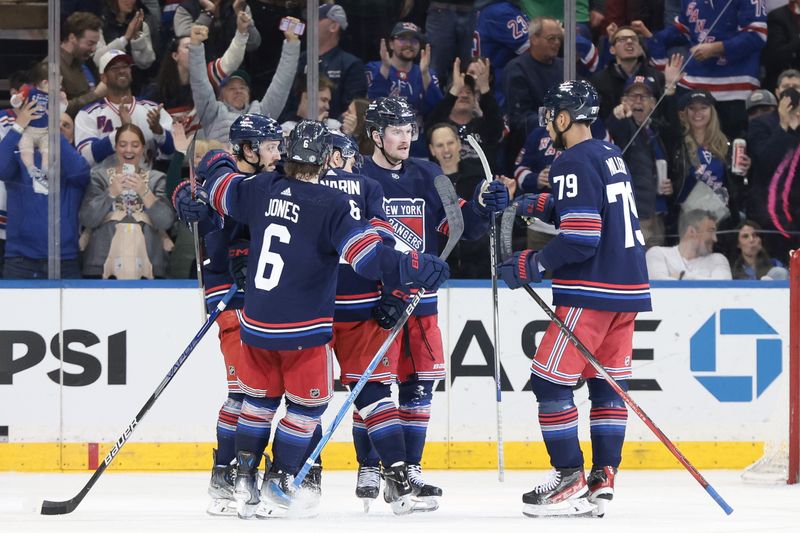 Mar 17, 2024; New York, New York, USA; New York Rangers left wing Alexis Lafreniere (13) celebrates his goal with teammates during the third period against the New York Islanders at Madison Square Garden. Mandatory Credit: Vincent Carchietta-USA TODAY Sports