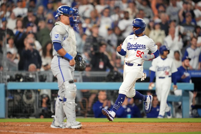 Jun 14, 2024; Los Angeles, California, USA; Los Angeles Dodgers shortstop Mookie Betts (50) rounds third base to score in the eighth inning as Kansas City Royals catcher Salvador Perez (13) watches at Dodger Stadium. Mandatory Credit: Kirby Lee-USA TODAY Sports
