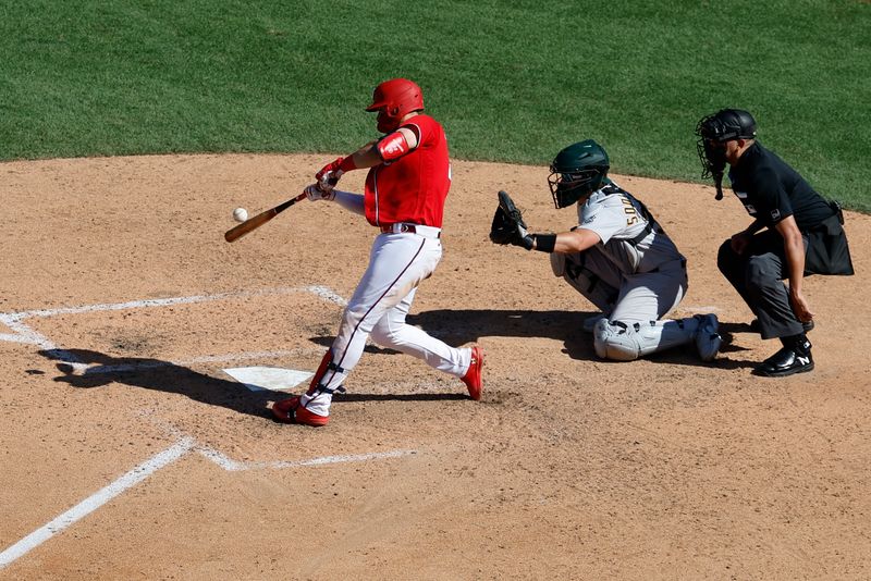 Aug 13, 2023; Washington, District of Columbia, USA; Washington Nationals first baseman Joey Meneses (45) singles against the Oakland Athletics during the ninth inning at Nationals Park. Mandatory Credit: Geoff Burke-USA TODAY Sports