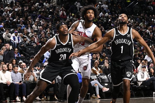 BROOKLYN, NY - DECEMBER 23: Day'Ron Sharpe #20 and Mikal Bridges #1 of the Brooklyn Nets boxes out during the game against the Detroit Pistons on December 23, 2023 at Barclays Center in Brooklyn, New York. NOTE TO USER: User expressly acknowledges and agrees that, by downloading and or using this Photograph, user is consenting to the terms and conditions of the Getty Images License Agreement. Mandatory Copyright Notice: Copyright 2023 NBAE (Photo by David Dow/NBAE via Getty Images)