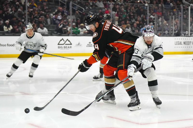 Apr 13, 2024; Los Angeles, California, USA; Anaheim Ducks defenseman Cam Fowler (4) and LA Kings right wing Viktor Arvidsson (33) battle for the puck in the second period at Crypto.com Arena. Mandatory Credit: Kirby Lee-USA TODAY Sports