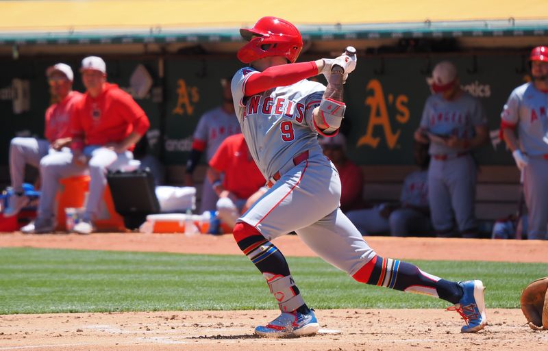 Jul 4, 2024; Oakland, California, USA; Los Angeles Angels shortstop Zach Neto (9) hits a single against the Oakland Athletics during the third inning at Oakland-Alameda County Coliseum. Mandatory Credit: Kelley L Cox-USA TODAY Sports