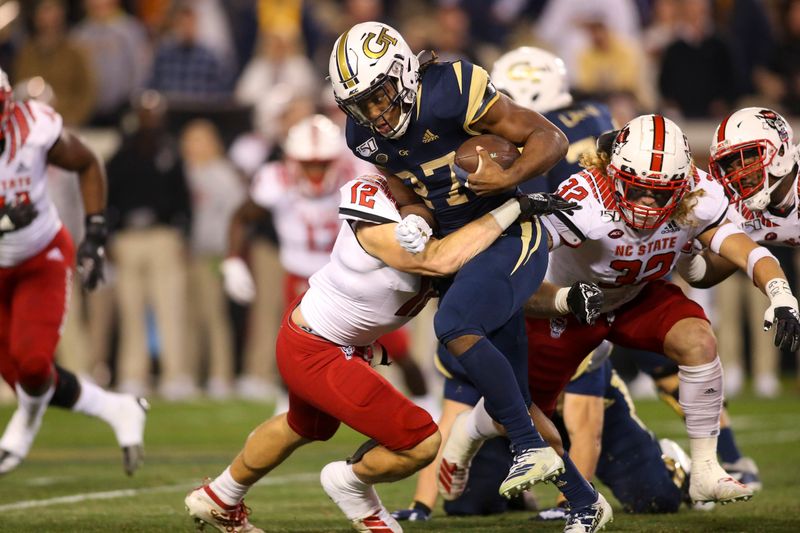 Nov 21, 2019; Atlanta, GA, USA; Georgia Tech Yellow Jackets running back Jordan Mason (27) runs the ball against the North Carolina State Wolfpack in the first half at Bobby Dodd Stadium. Mandatory Credit: Brett Davis-USA TODAY Sports