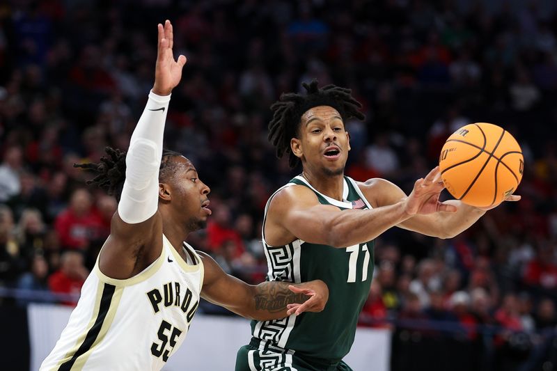 Mar 15, 2024; Minneapolis, MN, USA; Michigan State Spartans guard A.J. Hoggard (11) passes as Purdue Boilermakers guard Lance Jones (55) defends during the second half at Target Center. Mandatory Credit: Matt Krohn-USA TODAY Sports