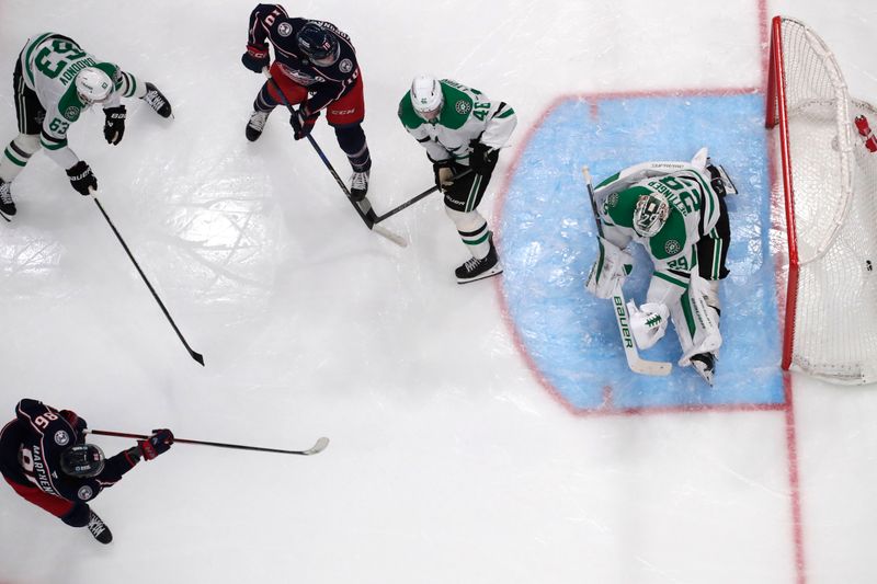 Feb 25, 2025; Columbus, Ohio, USA; Columbus Blue Jackets right wing Kirill Marchenko (86) scores a goal against Dallas Stars goalie Jake Oettinger (29) during the second period at Nationwide Arena. Mandatory Credit: Russell LaBounty-Imagn Images