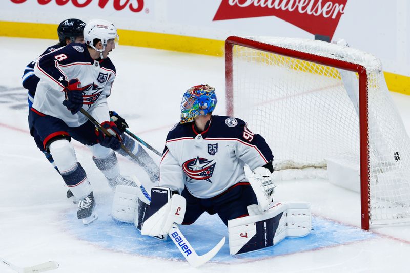 Nov 18, 2025; Winnipeg, Manitoba, CAN;  Winnipeg Jets defenseman Josh Morrissey (44) scores on Columbus Blue Jackets goalie Elvis Merzlikins (90) during the second period at Canada Life Centre. Mandatory Credit: Terrence Lee-Imagn Images