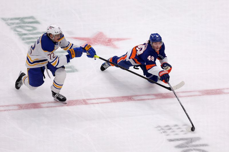 Jan 24, 2026; Elmont, New York, USA; New York Islanders defenseman Matthew Schaefer (48) dives for the puck against Buffalo Sabres center Tage Thompson (72) during the third period at UBS Arena. Mandatory Credit: Brad Penner-Imagn Images