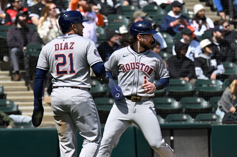 May 3, 2025; Chicago, Illinois, USA;  Houston Astros catcher Yainer Diaz (21) and  second baseman Brendan Rodgers (1) high five after they score against the Chicago White Sox during the fourth inning at Rate Field. Mandatory Credit: Matt Marton-Imagn Images